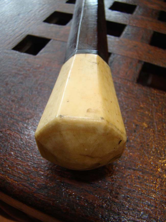 A fine 19th century Captain's rosewood walking stick having an octagonal shaft and octagonal carved whale ivory knob.